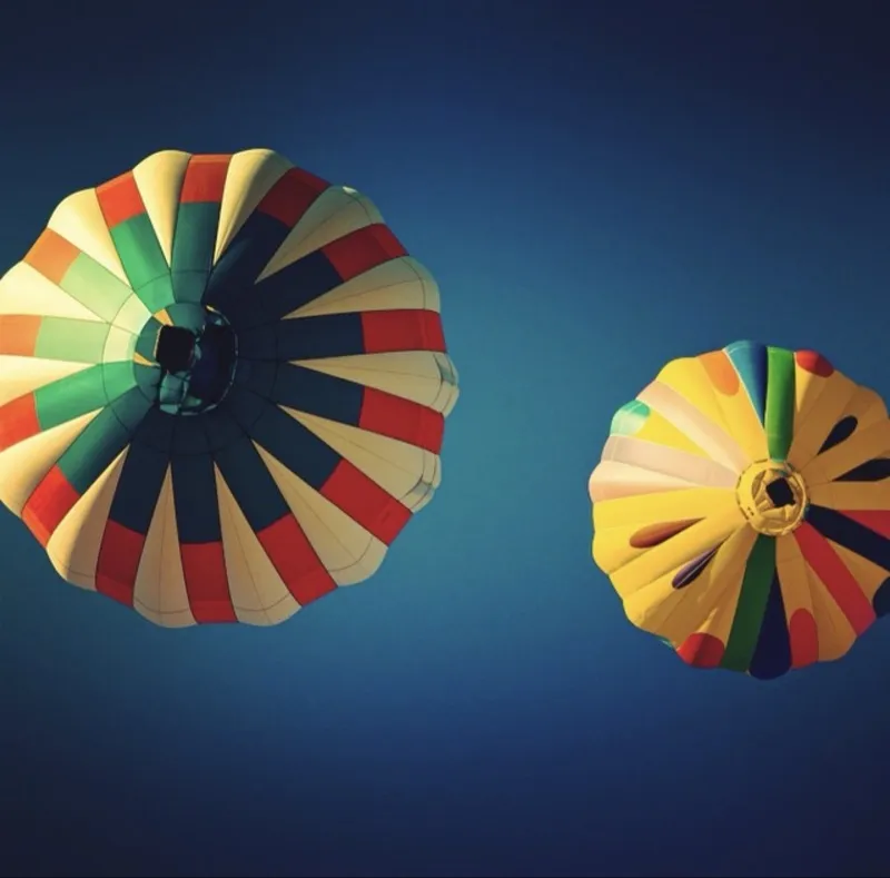 Two hot air balloons against a deep blue sky — Colorado Springs Balloon Festival